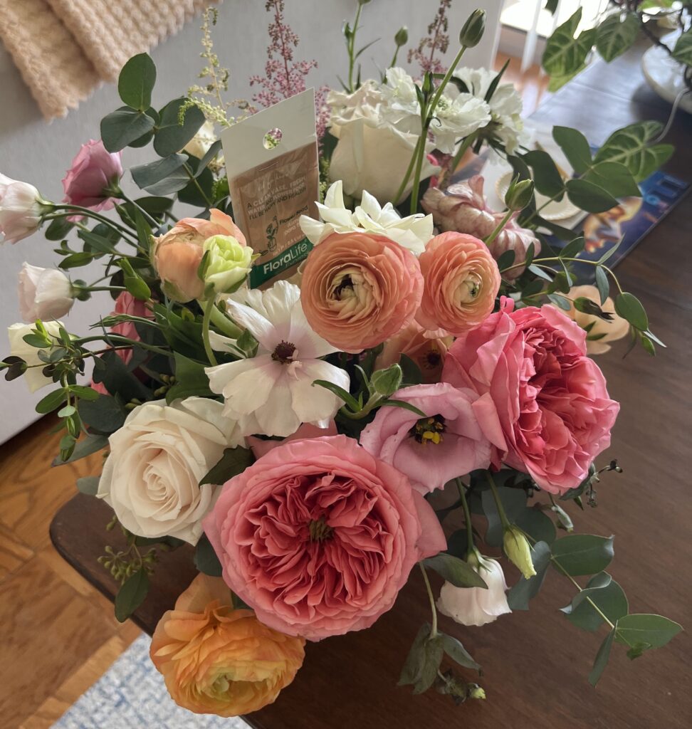 coral colored ranunculus in a bouquet