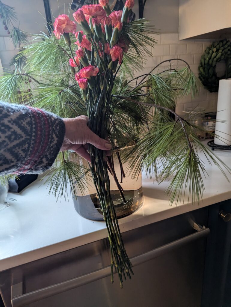 A bouquet of measured stems held next to the container