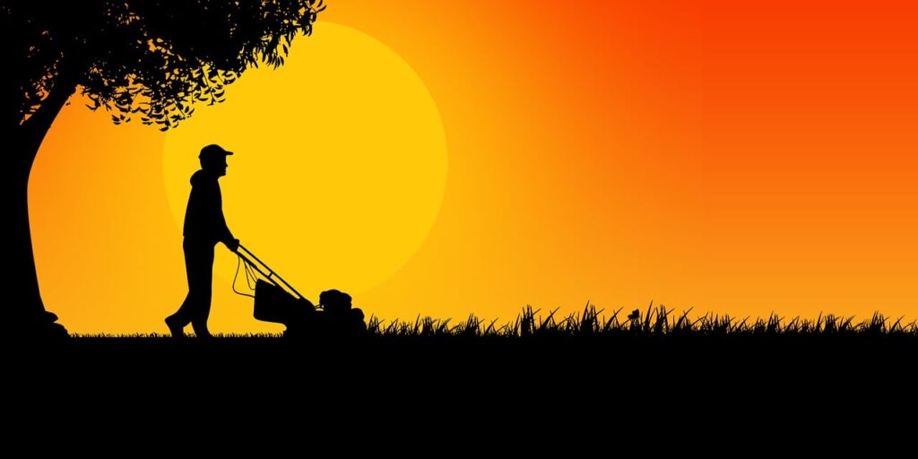 silhouette of man mowing lawn at / pixabay