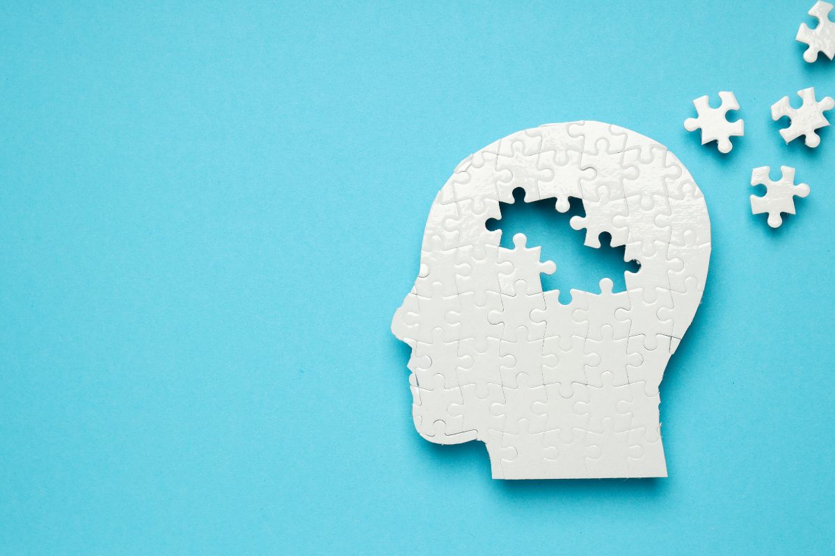 outline of persons head depicted as puzzle pieces with a few pieces missing
